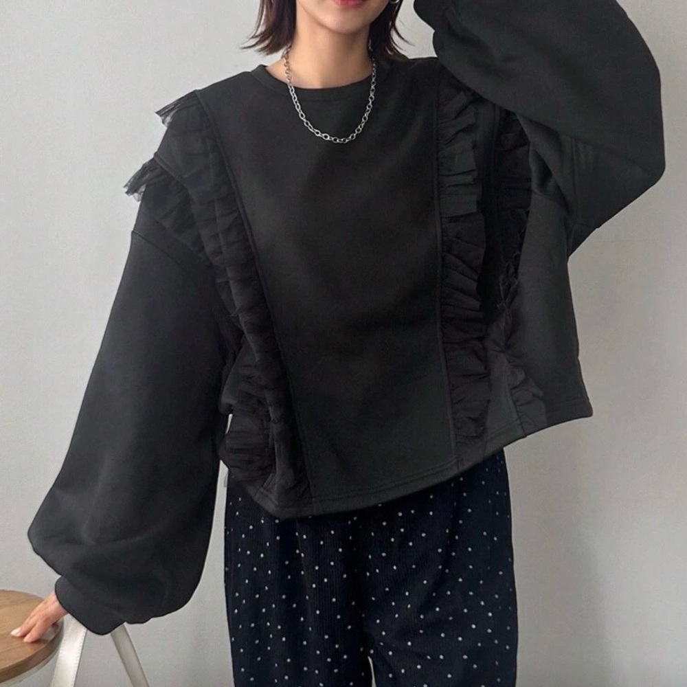 Black cropped sweatshirt with lace ruffle detail.